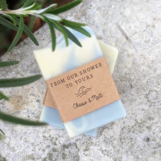 Handmade soap bars with light blue and cream coloured swirls, labelled as 'From our shower to yours' with a lavender plant in the background.