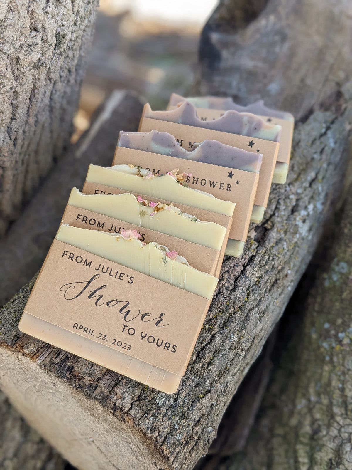 Set of personalized soap bars on a wooden surface