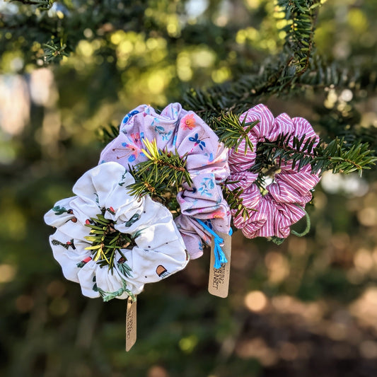 Three colourful scrunchies in an outdoor setting