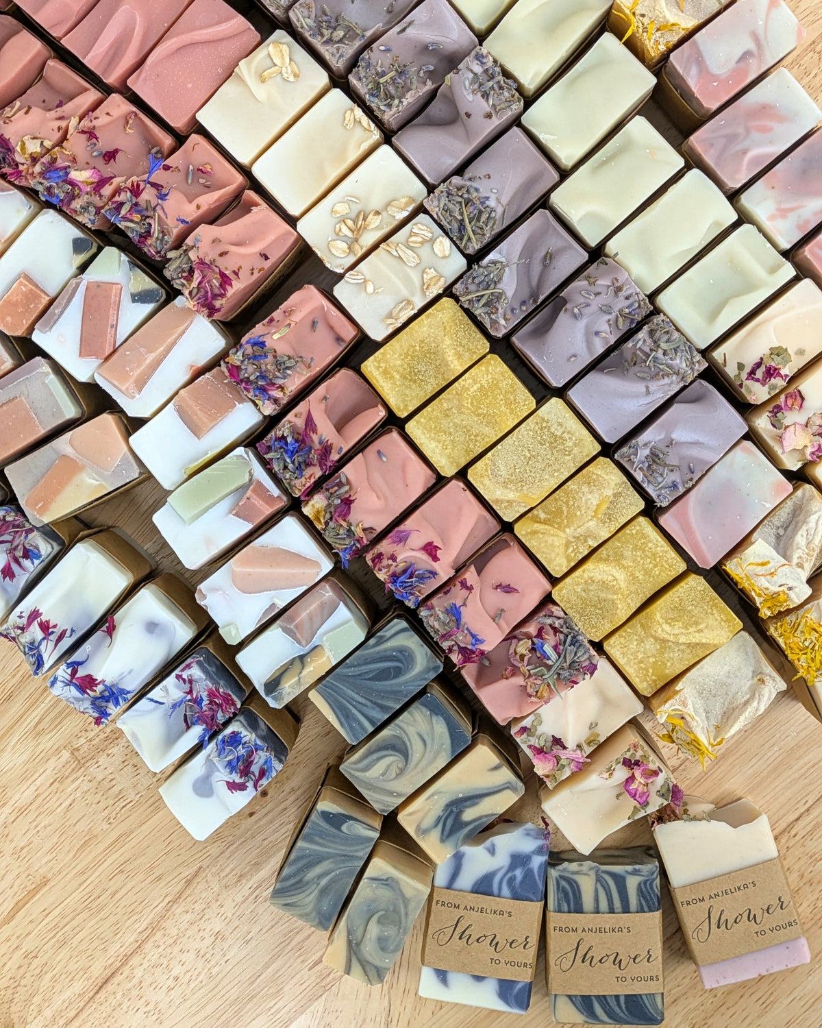 A table full of handmade soap bars with floral decorations on top