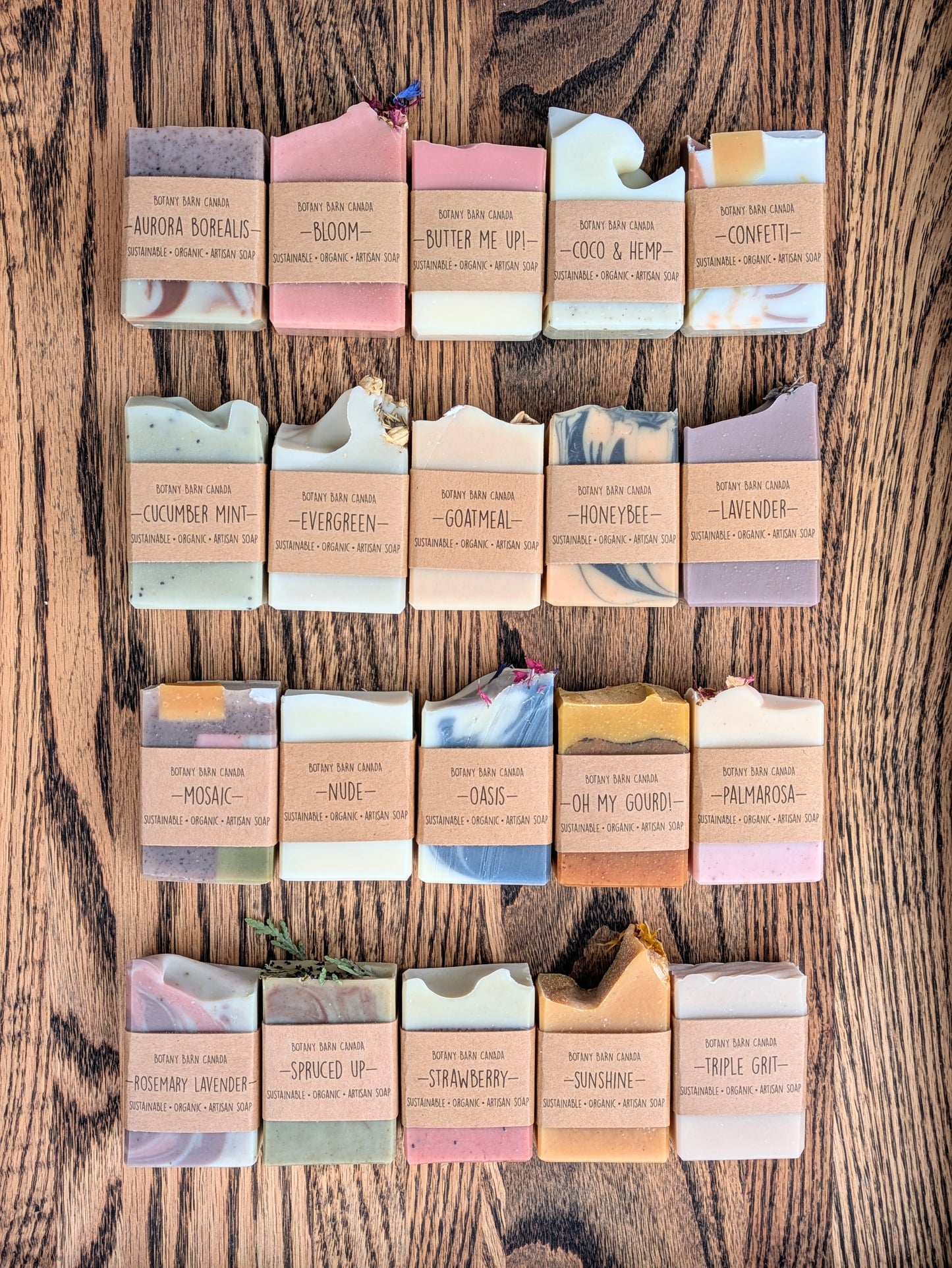 Assorted soap bars with visible brand names on a wooden surface