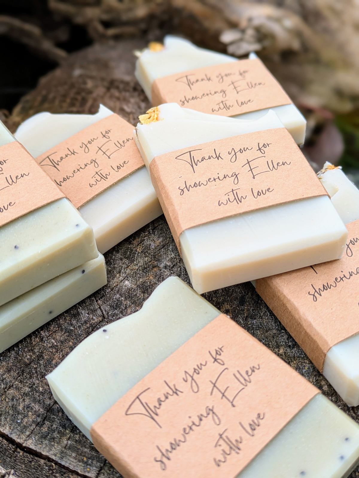 Bars of soap with personalized tags on a wooden surface