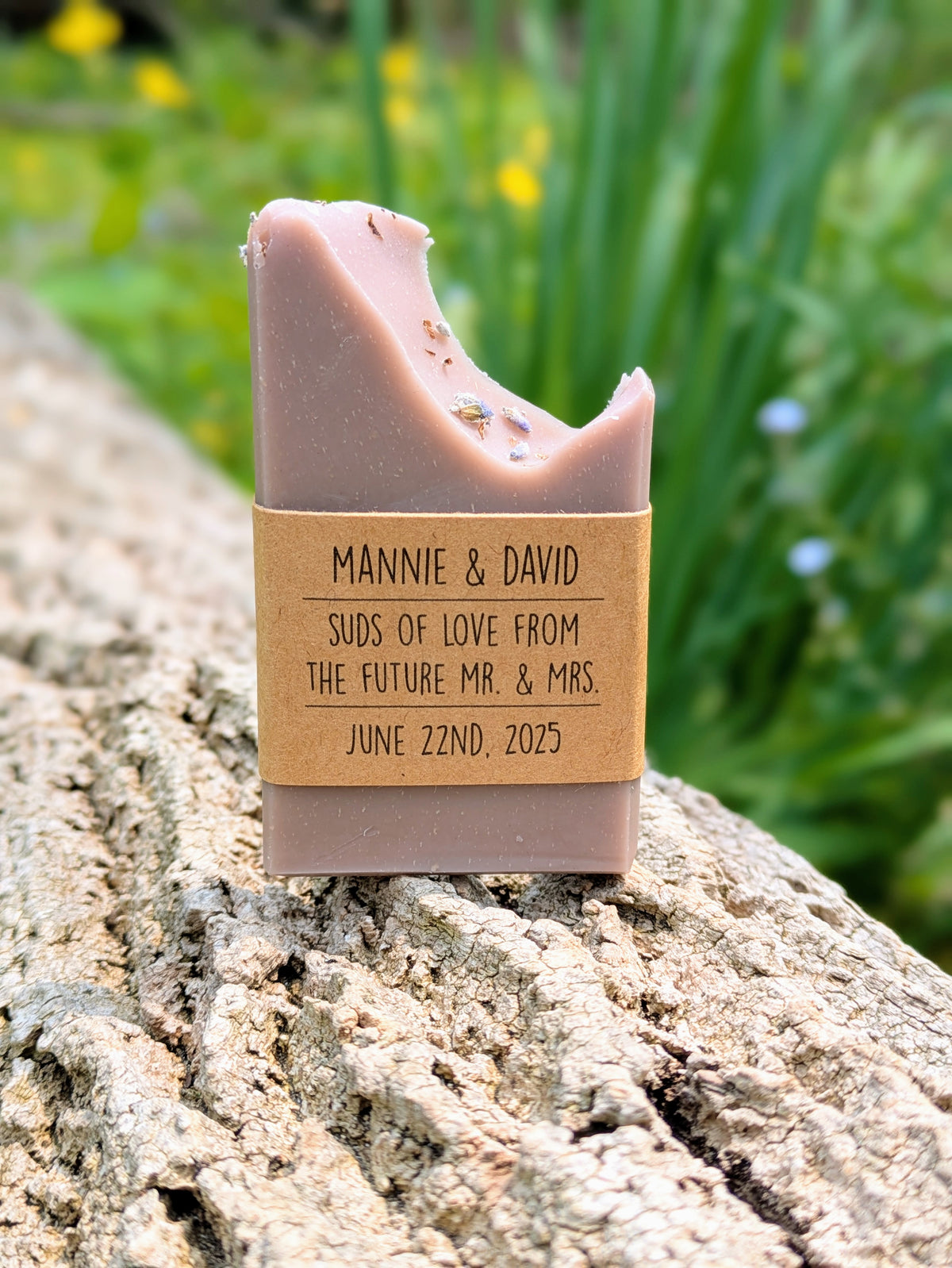 Bar of soap with a personalized label on a stone surface with a natural background