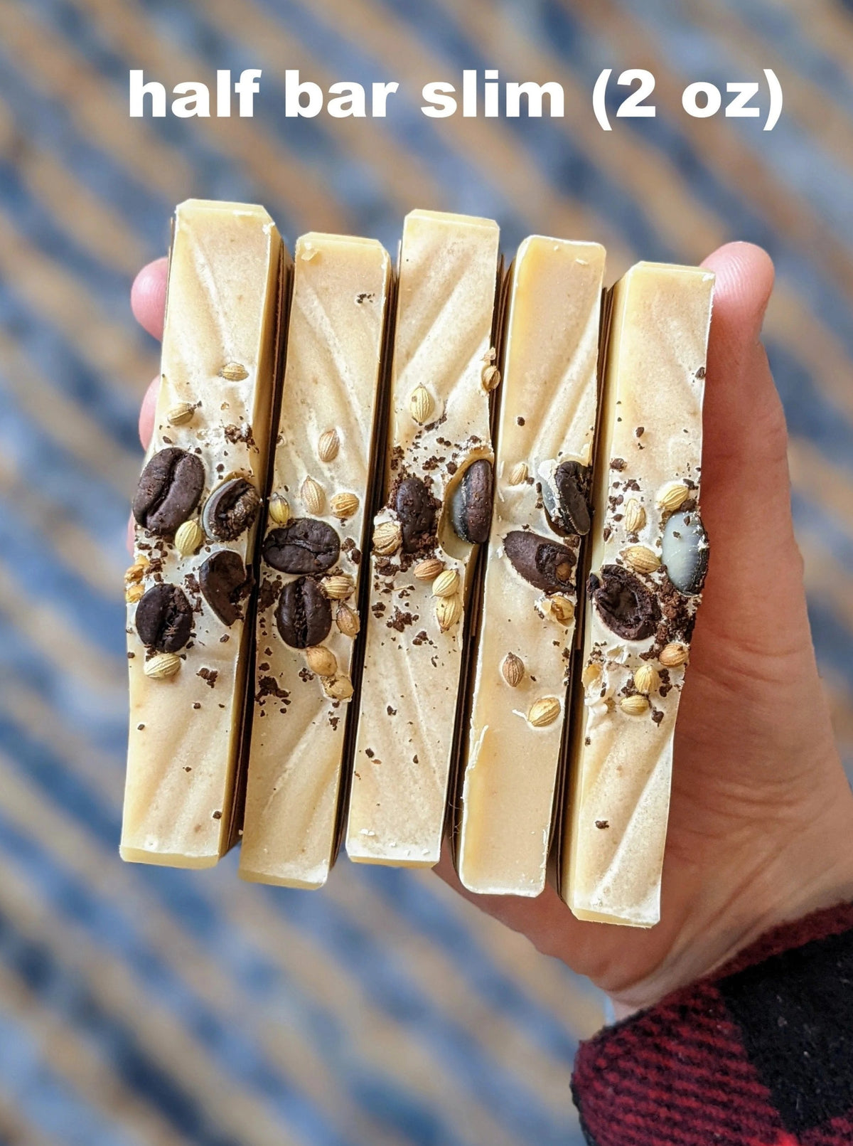 Five handmade soap bars held in a hand