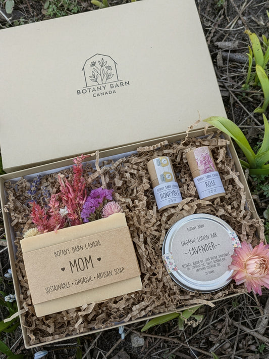 Gift set with Botany Barn Canada products including soap, lip balm, and a lotion bar on natural background.