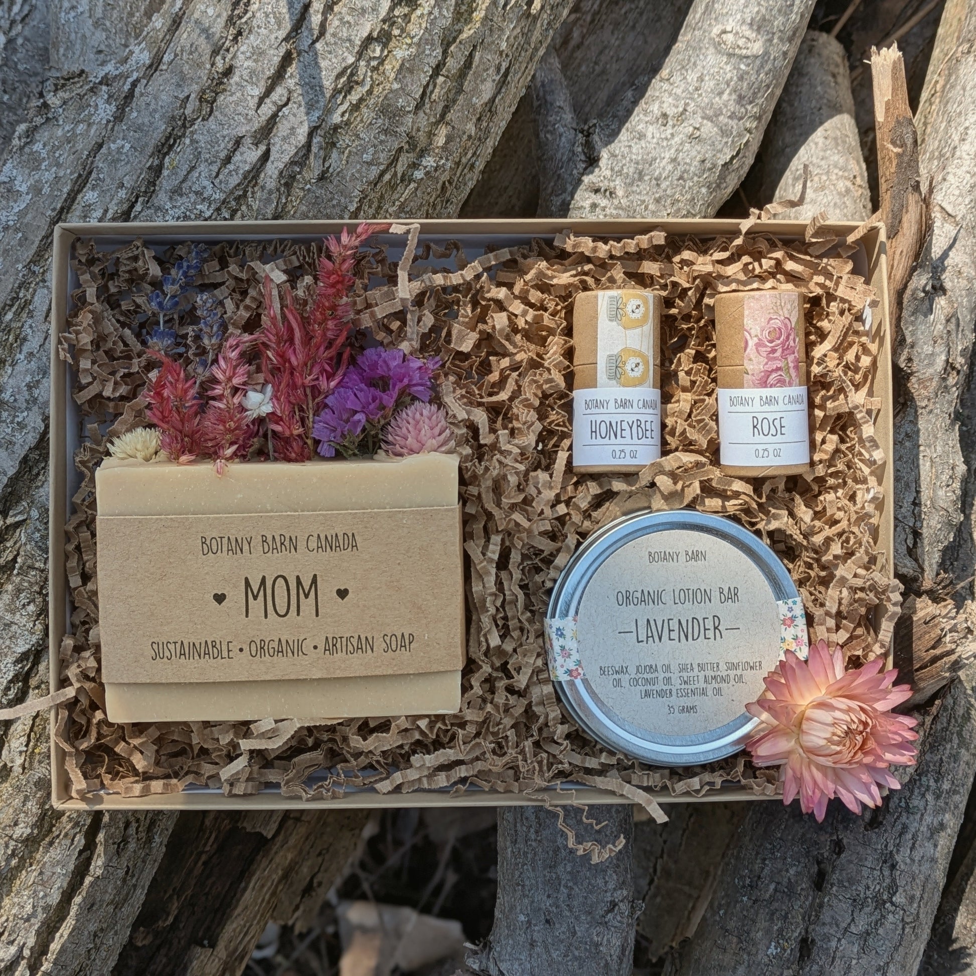 Gift set with soaps and flowers on a stone background
