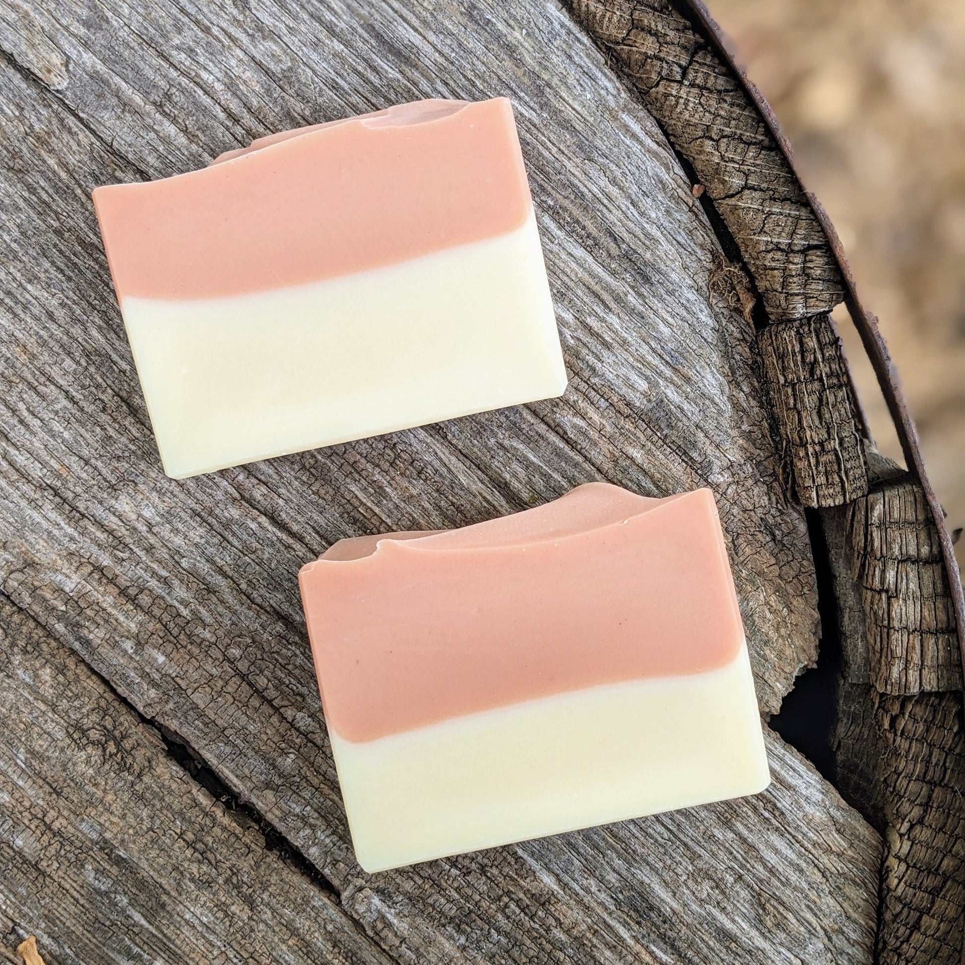 Two layered soap bars on a wooden surface